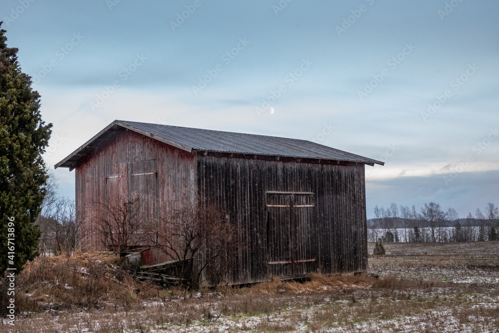 barn with a moon in the background