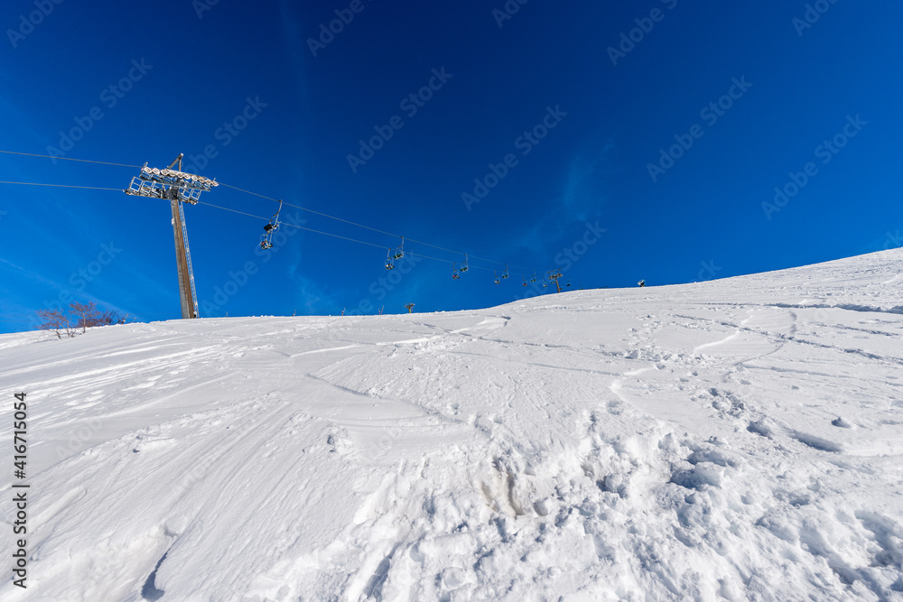 Obraz premium Empty Chairlift in snowy winter landscape. Malga San Giorgio ski resort. Altopiano della Lessinia (Lessinia Plateau), Regional Natural Park, Verona province, Veneto, Italy, Europe.
