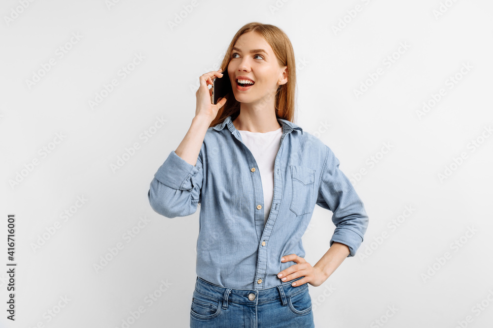happy young woman talking on mobile phone and laughing on white background happy young woman talking on mobile phone and laughing on white background