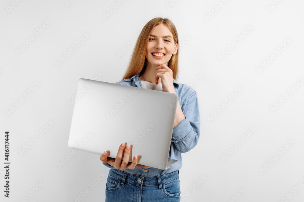 smiling young woman, blonde holding laptop computer on isolated white background smiling young woman, blonde holding laptop computer on isolated white background