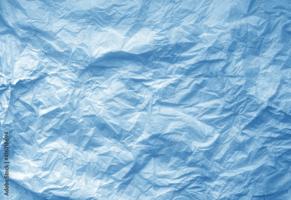 Fototapeta premium Crumpled blue paper sheet surface.