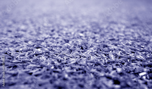 Blue color artificial grass close-up with blur background