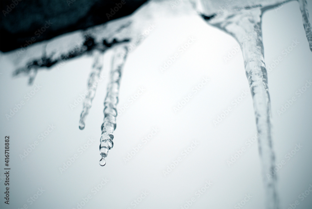 Monochrome image of melting icicles on the roof. Monochrome image of melting icicles on the roof.