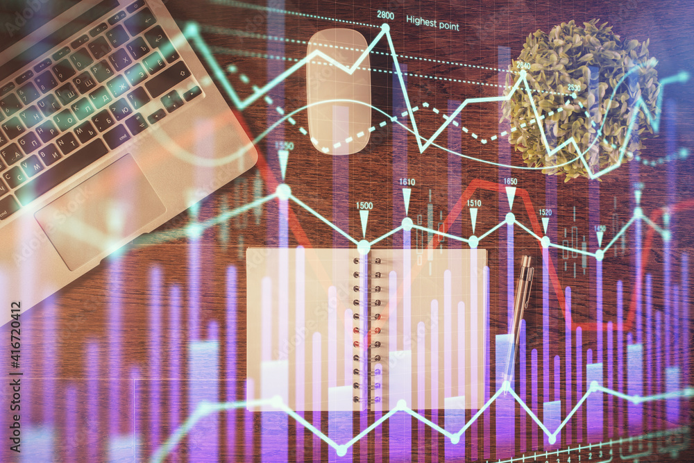 Stock market graph and top view computer on the table background. Double exposure. Concept of financial education. Stock market graph and top view computer on the table background. Double exposure. Concept of financial education.