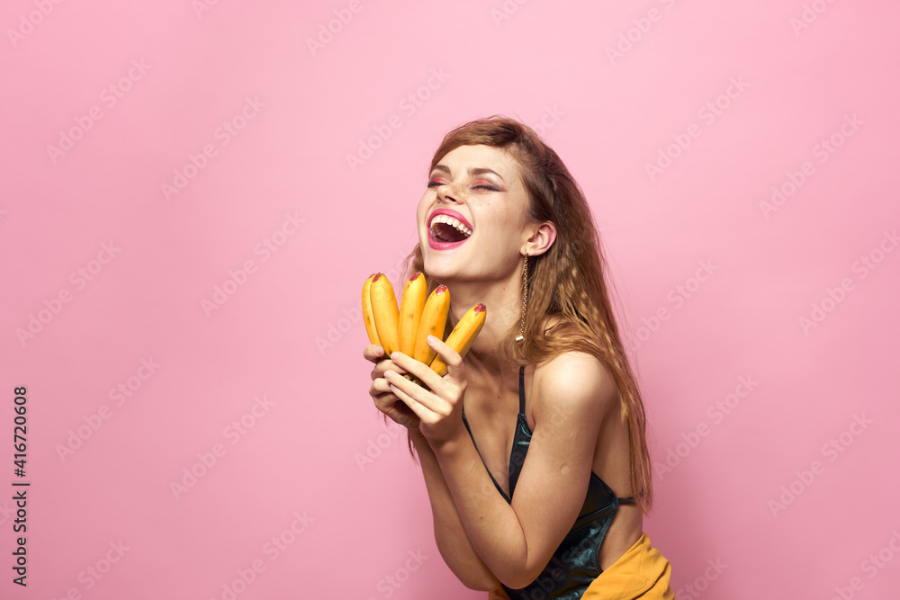 Beautiful woman with bananas in hands straw hat emotions pink background Beautiful woman with bananas in hands straw hat emotions pink background