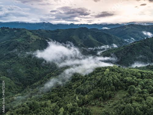 Aerial view of green mountain in cloudy day