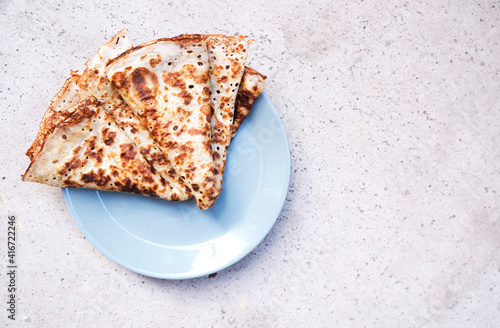 A few pancakes on a light grey background. Top view. Flat lay. photo