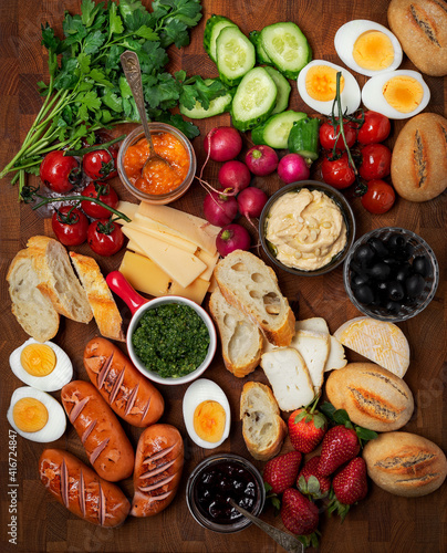 Breakfast or brunch board for the whole family with sauseges, eggs, breads and vegetables