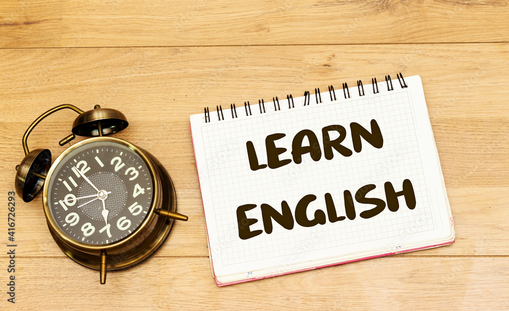 learn english concept on notebook with alarm clock showing 7 am or pm learn english concept on notebook with alarm clock showing 7 am or pm