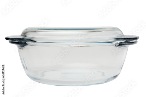 Round-shaped glass casserole with handles. Isolated on a white background, side view close-up