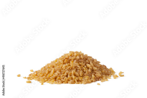 A small slide of dry bulgur on the table. photo