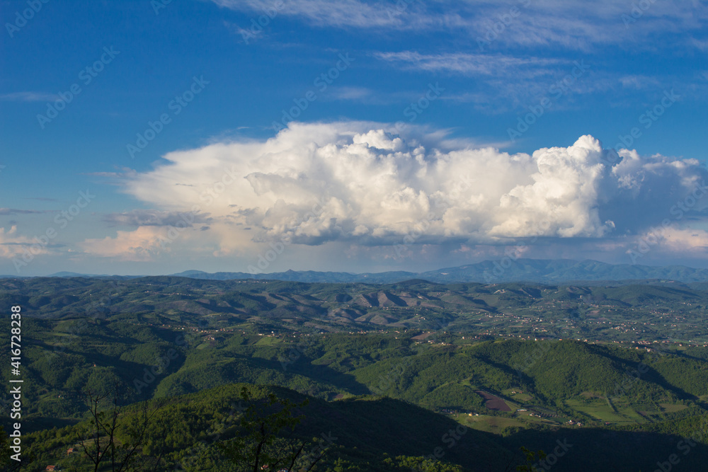A large beautiful cloud over the expanse of western Serbia. View from Mount Kablar.