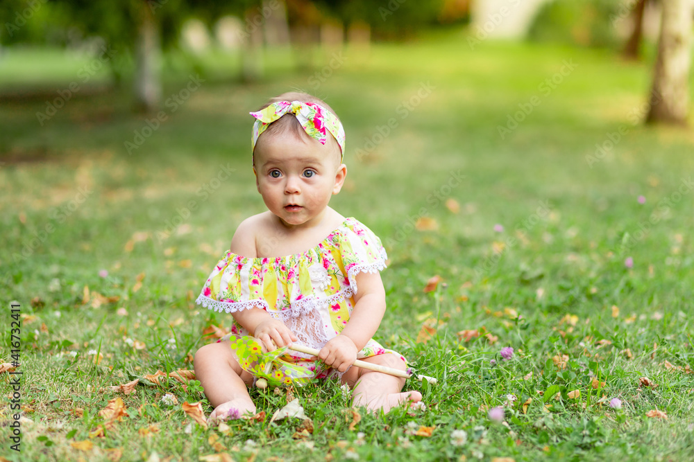 baby on the lawn or grass in the summer, baby walking in the fresh air baby on the lawn or grass in the summer, baby walking in the fresh air