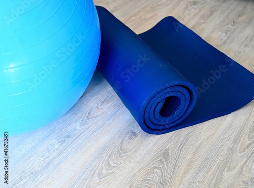 Exercise for healthy lifestyle concept. Fitness mat and fitness ball lies on the floor.