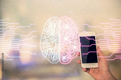 Double exposure of brain sketch hologram and woman holding and using a mobile device.