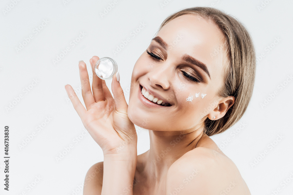 Facial skin care, skin cream. Rejuvenation 30+. Close up of a beautiful woman with clean skin and with cream in her hands Facial skin care, skin cream. Rejuvenation 30+. Close up of a beautiful woman with clean skin and with cream in her hands