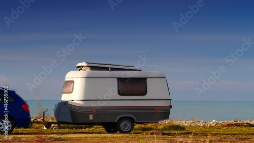Caravan trailer wild camping on seashore. Capicorb, Valencia region Spain. Travelling, vacation with mobile home. photo