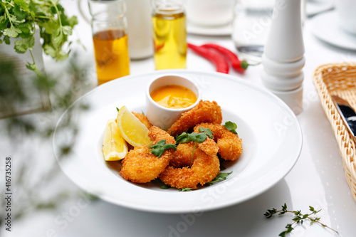Shrimps in panko with mango sauce. A tasty appetizer. Suggestion to serve the dish. Culinary photography.