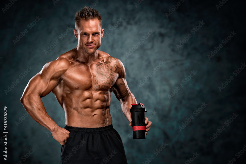 Protein Drink. Muscular Men Holding Nutritional Supplement Drink In His Hand