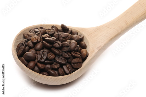 Coffee beans pile with wooden spoon isolated on white background