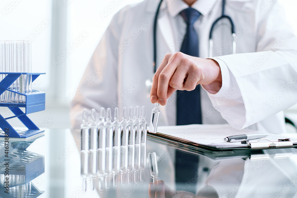 young scientist works in a clinical laboratory. young scientist works in a clinical laboratory.