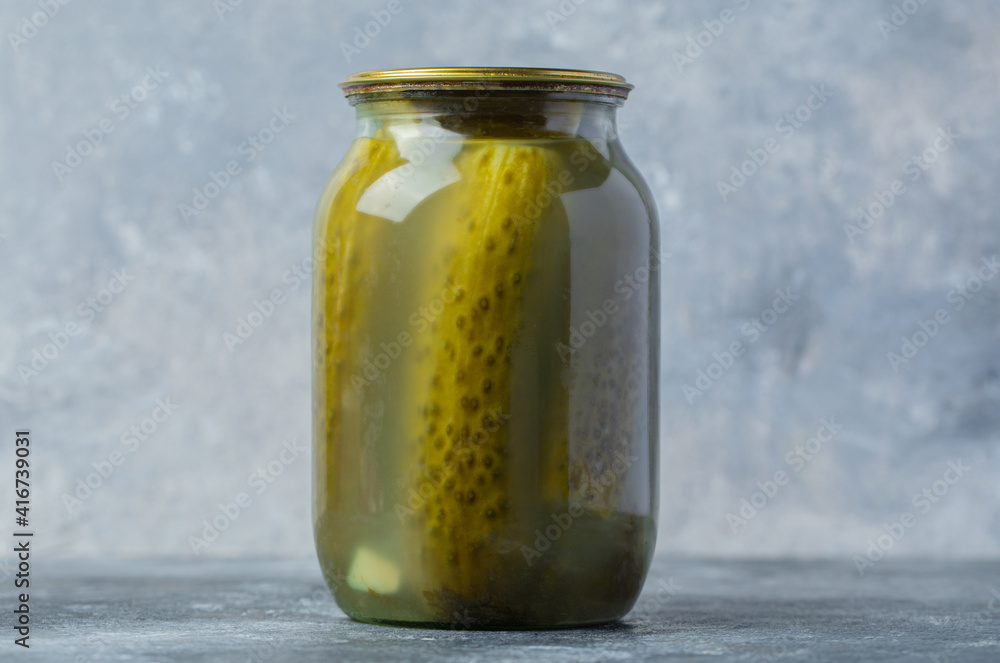 Close up photo of pickle jar on grey background. Close up photo of pickle jar on grey background.