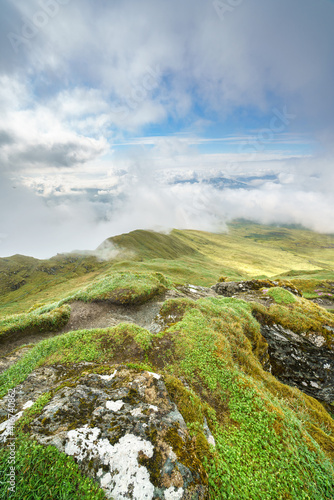 The narrow mountain ridge, summit of Meall Garbh with the cloud covered summits of Meall Liath in the distance in the Scottish Highlands, UK landscapes.