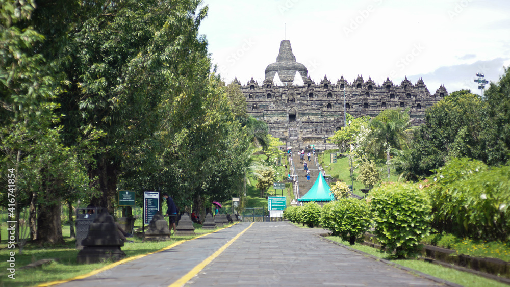 MAGELANG, INDONESIA-18 FEBRUARY 2021: Sighting of the road and trees that decorate the road from the entrance to the Borobudur temple tourist attraction