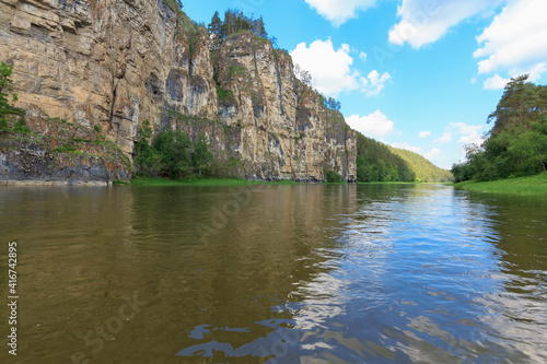 Colorful landscape with mountains and a beautiful calm river in Russia. River Ay. Summer, river rafting