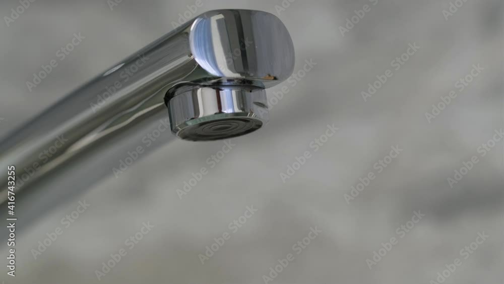 Dripping old faucet. Water dripping from a tap close up. Lack of clean water, reckless use of resources. Tap water dripping. Plumbing chromed mixer Dripping old faucet. Water dripping from a tap close up. Lack of clean water, reckless use of resources. Tap water dripping. Plumbing chromed mixer