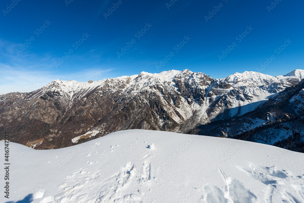 Snow capped mountains in winter of the Monte Carega, called the small Dolomites from the Altopiano della Lessinia (Lessinia High Plateau). Veneto and Trentino Alto Adige, Italy, Europe.