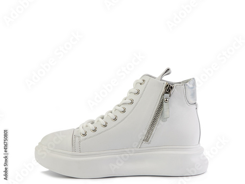 High ankle casual white leather trainers. White lacing, a zipper on side, silver details and white rubber soles. Isolated close-up on white background. Left side view. Fashion shoes.