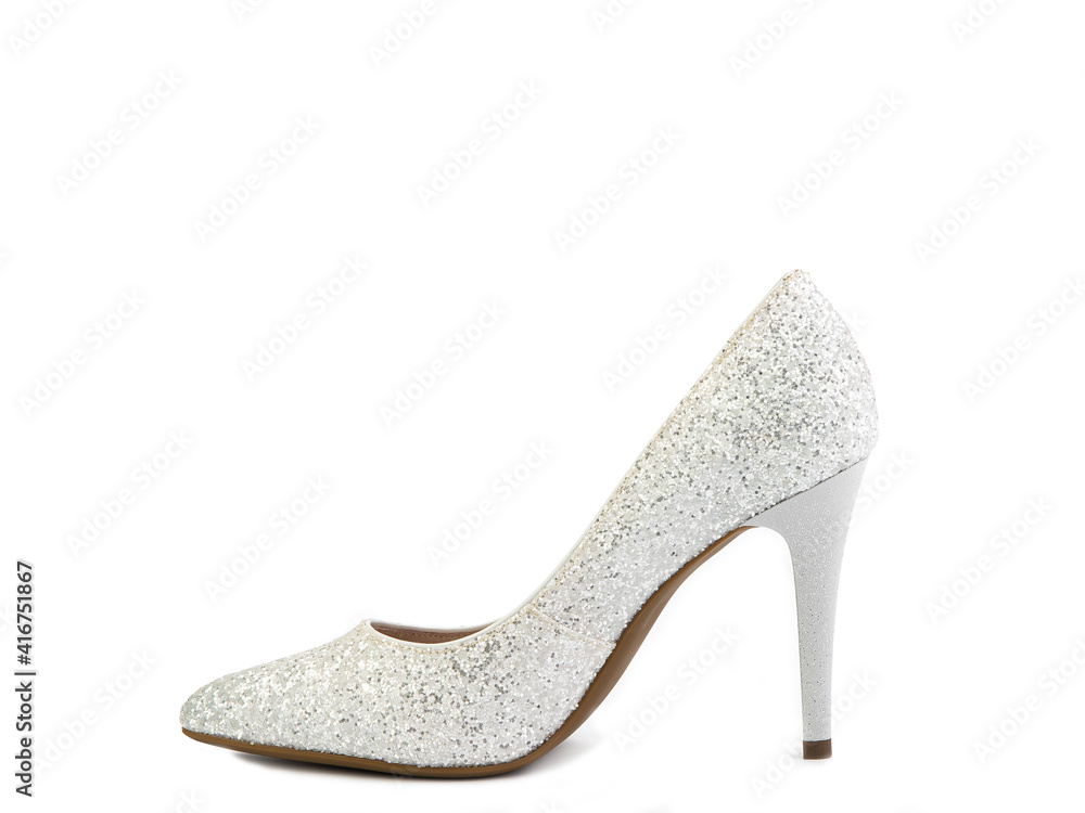 Obraz premium Elegant, glamorous and sparkly high-heeled women shoes. White shoes with silver glitters and a high silver heel. Isolated close-up on white background. Left side view. Fashion shoes.