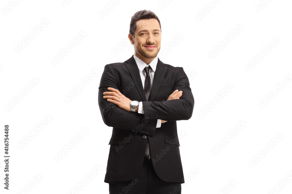 Young busniessman wearing a black suit and posing with arms crossed Young busniessman wearing a black suit and posing with arms crossed