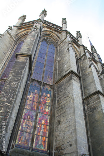 A stained glass window in the basilica in the centre of the town of Meerssen, Limburg, the Netherlands, seen from the outside looking up to the roof