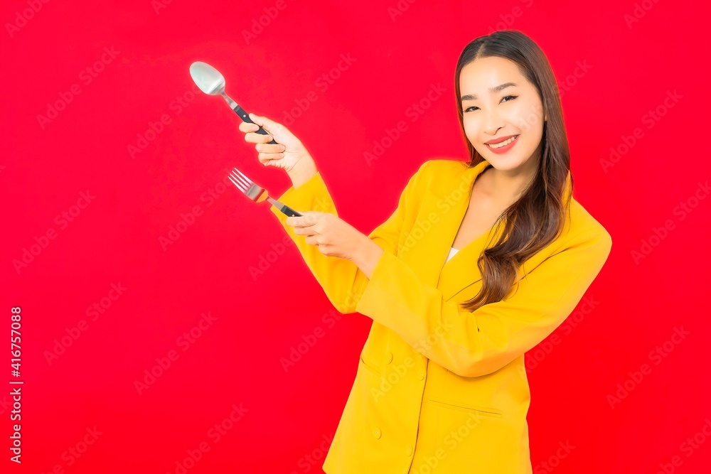 Portrait beautiful young business asian woman with spoon and fork Portrait beautiful young business asian woman with spoon and fork