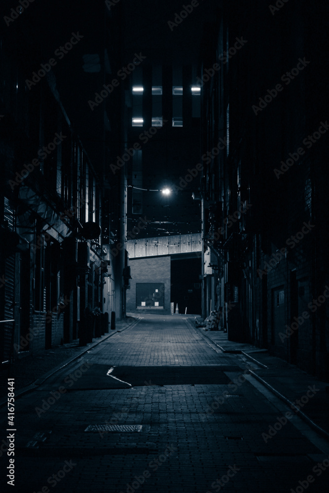 Moody monochrome shot of a dark alley