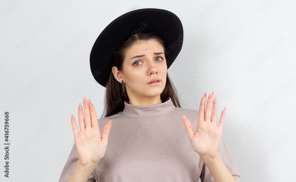 Attractive woman saying thanks but no. Beautiful girl denying proposal, making stop gesture with her hands, looking at camera Attractive woman saying thanks but no. Beautiful girl denying proposal, making stop gesture with her hands, looking at camera
