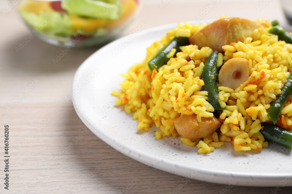 Delicious pilaf with chicken meat on wooden table, closeup Delicious pilaf with chicken meat on wooden table, closeup