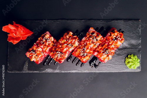 Traditional japanese food, Mix colorful sushiSet of different kinds of sushi rolls with salmon, shrimp and vegetables. On black rustic background. Top view. photo