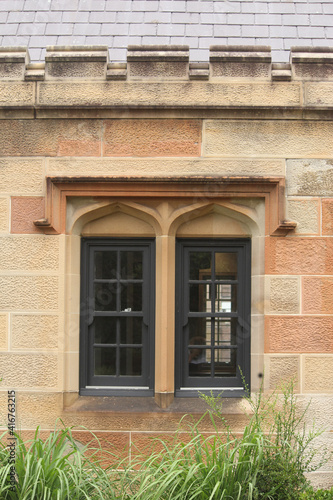 Sandstone facade, windows and slate roof of Gardener’s Lodge in Victoria Park, Sydney
