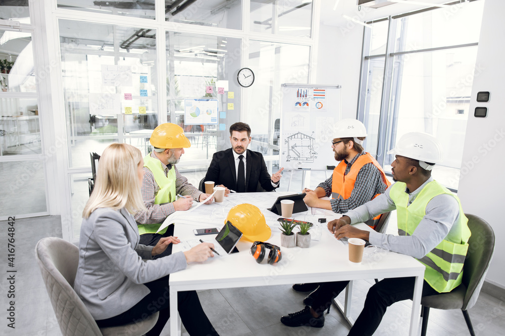 Group of multiracial people discussing construction project