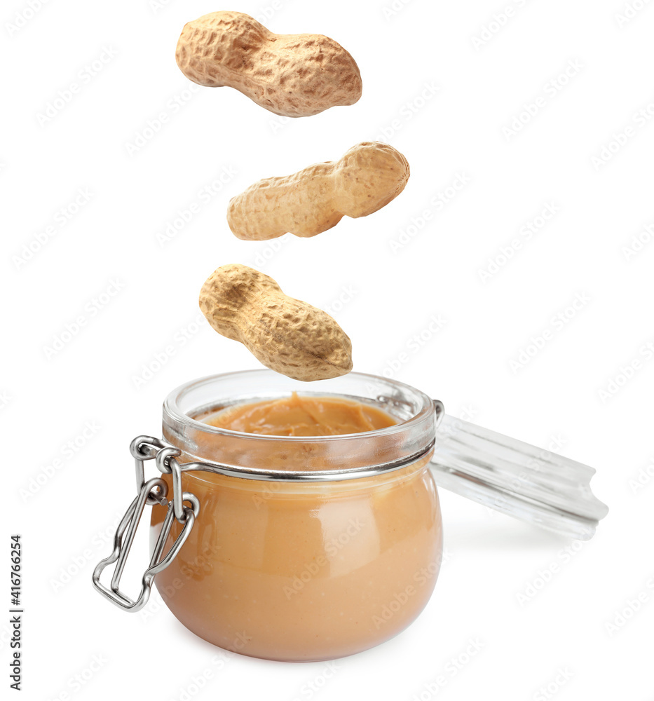Delicious peanut butter in glass jar on white background Delicious peanut butter in glass jar on white background