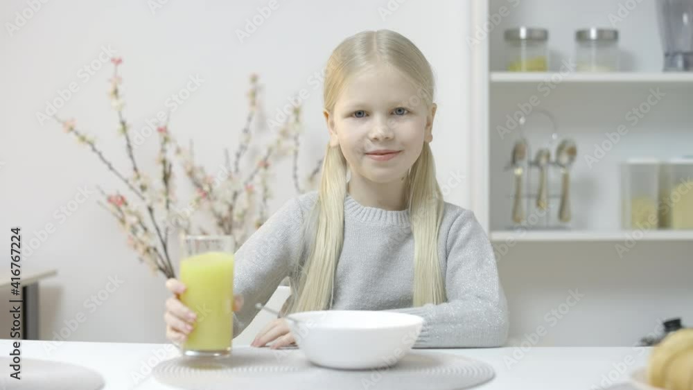 Young girl drinking fresh juice and smiling, healthy nutrition and vitamins Young girl drinking fresh juice and smiling, healthy nutrition and vitamins