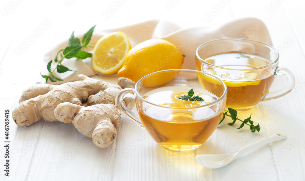 Herbal ginger tea boost your immune, two glass mugs of healthy hot drink Herbal ginger tea boost your immune, two glass mugs of healthy hot drink