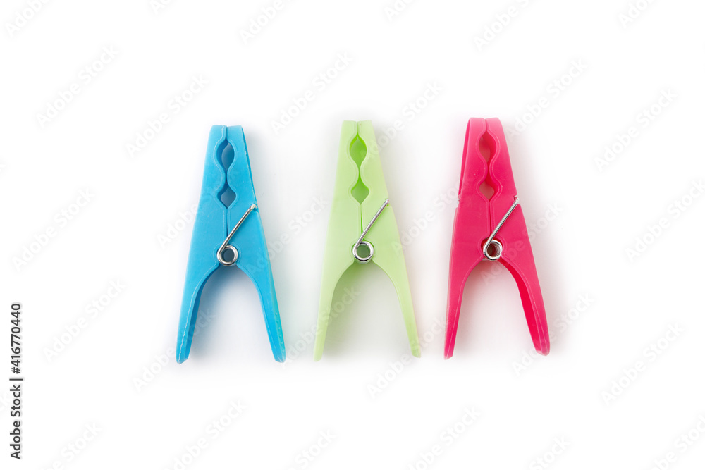 top view of three different color clothespins isolated on white background top view of three different color clothespins isolated on white background