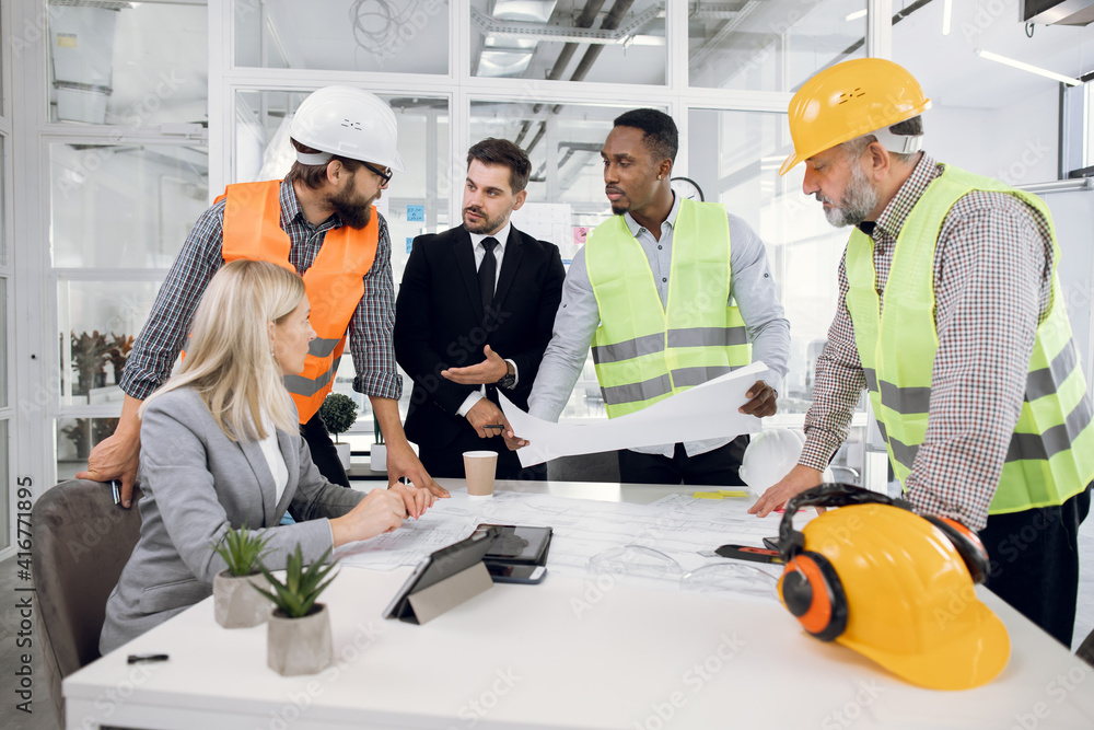 Diverse high-skilled multiethnic people creating project of building Diverse high-skilled multiethnic people creating project of building