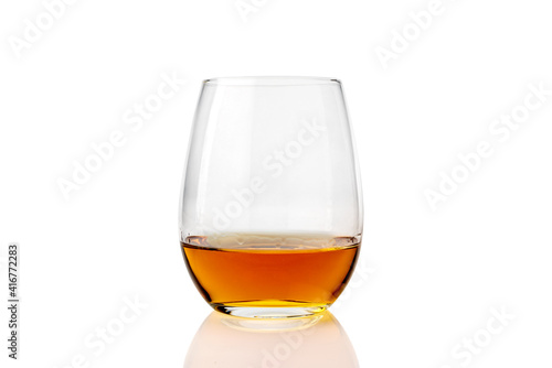 glass of whiskey or whisky or american Kentucky bourbon with its reflection on the plane. isolated on white