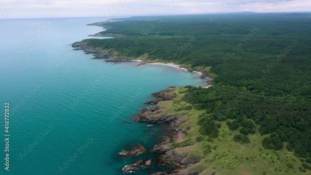 Drone flight above a picturesque rocky coastline with small wild beaches and green forests on the southern coast of the Black Sea, Bulgaria Drone flight above a picturesque rocky coastline with small wild beaches and green forests on the southern coast of the Black Sea, Bulgaria