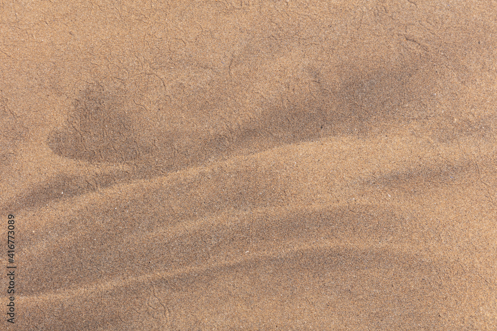 Close up abstract image of golden sand at a beach with beautiful natural patterns. Close up abstract image of golden sand at a beach with beautiful natural patterns.